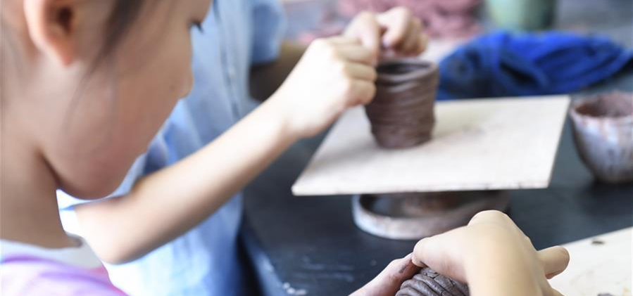         8月6日，孩子們在吳興區(qū)青少年活動中心參加陶藝制作課。